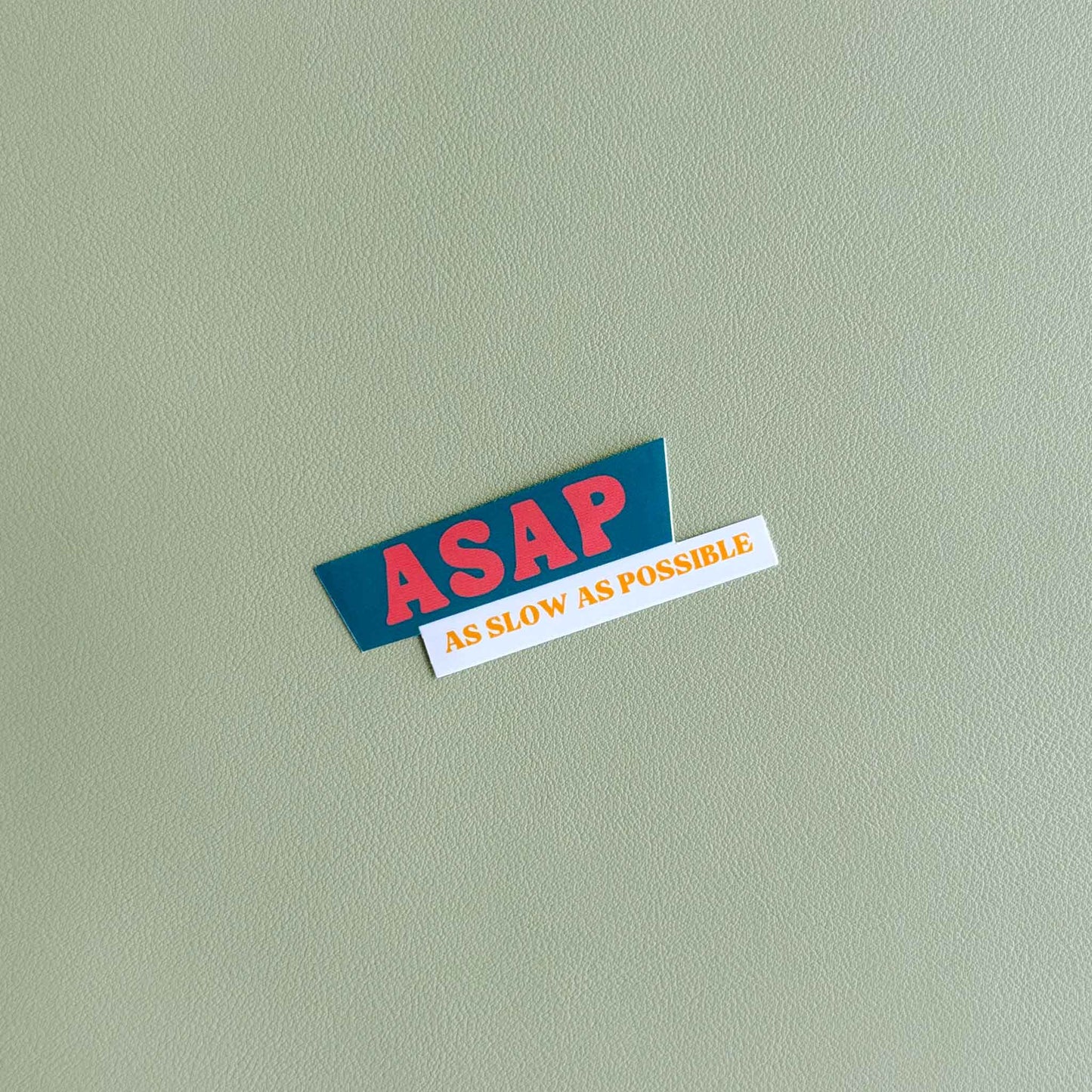 Vinyl sticker that reads 'ASAP' in bold dark orange text above 'As slow as possible' in orange text on white