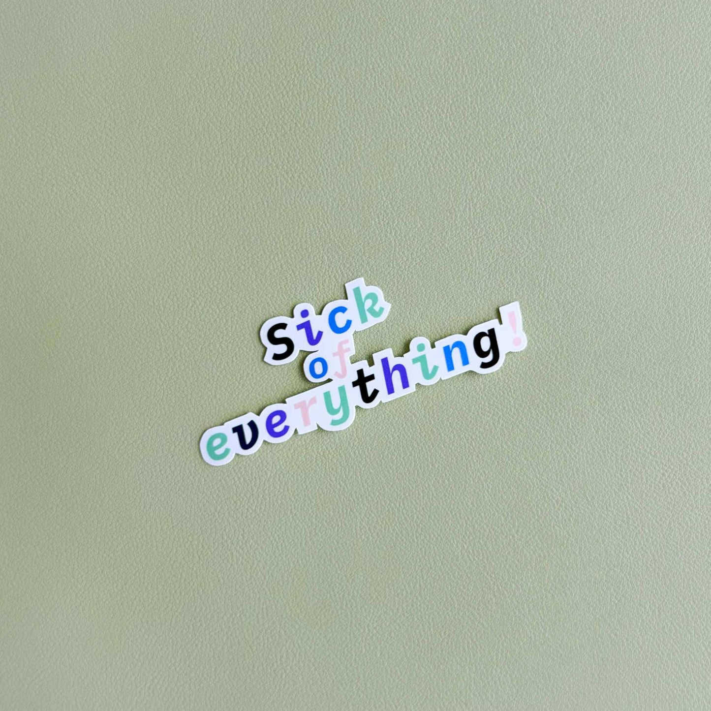 Vinyl sticker that reads 'Sick of everything!' in a playful colorful script font