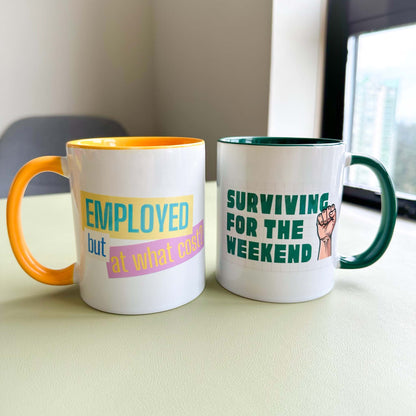 'Surviving for the weekend' mug with green interior beside the matching 'Employed but at what cost?' mug with yellow interior