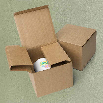 'Employed but at what cost?' mug nestled in its brown cardboard packaging box