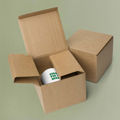 'Surviving for the weekend' mug nestled in its brown cardboard packaging box