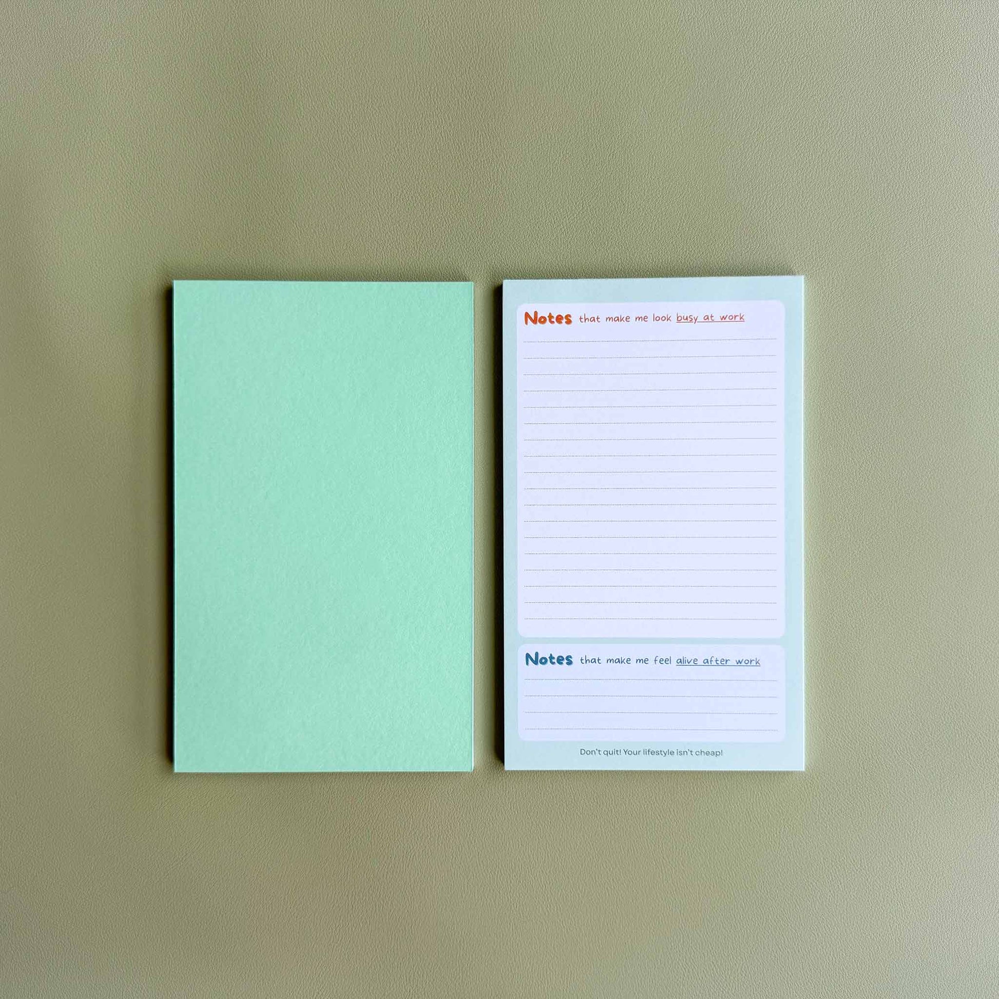 Two 'Busy at work, alive after work' dual-section notepads — one face up showing the dual 'Notes' layout and one face down showing the green back