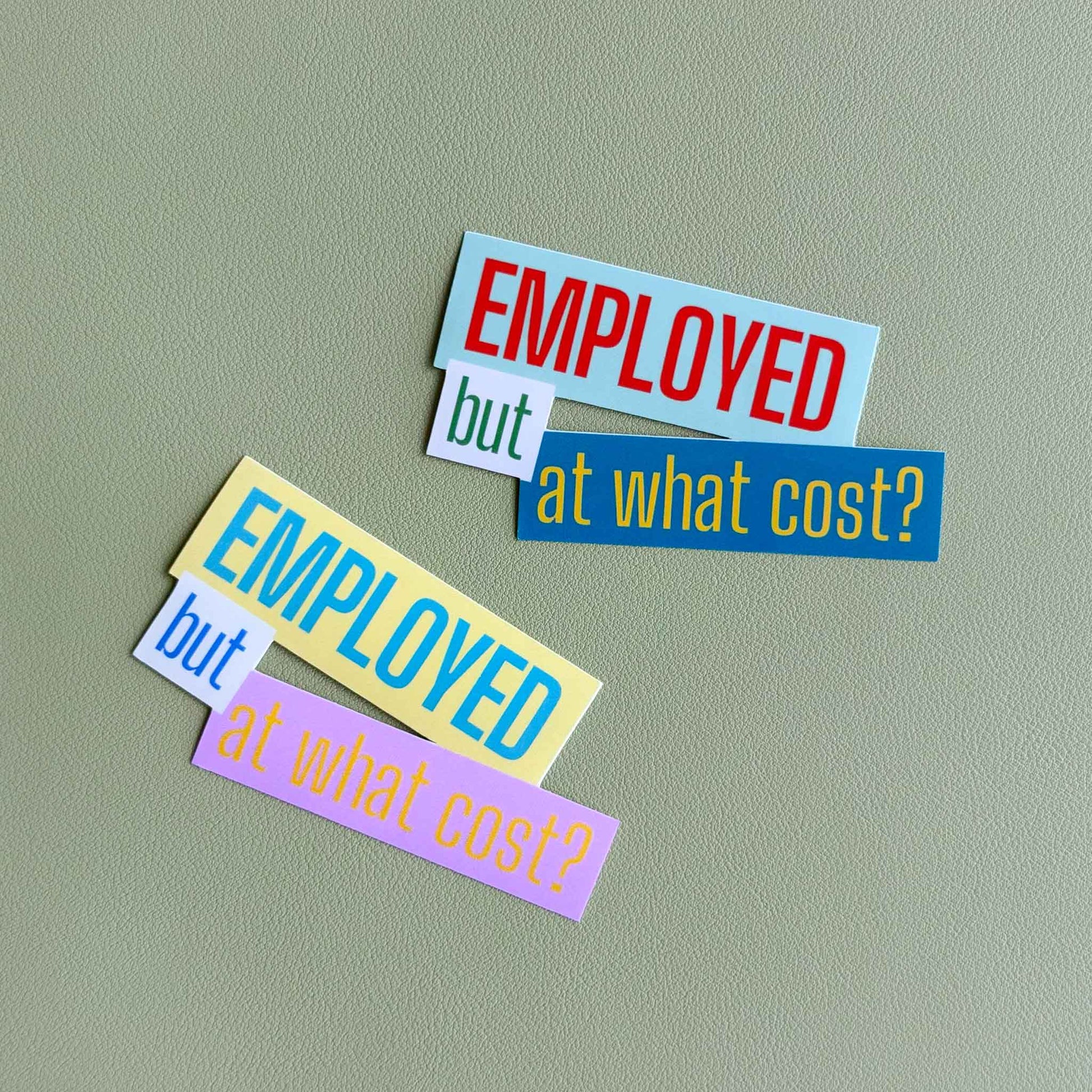 Two 'Employed but at what cost?' vinyl stickers shown side by side in different colorways — one in light blue, white, and green, the other in yellow, white, and pink