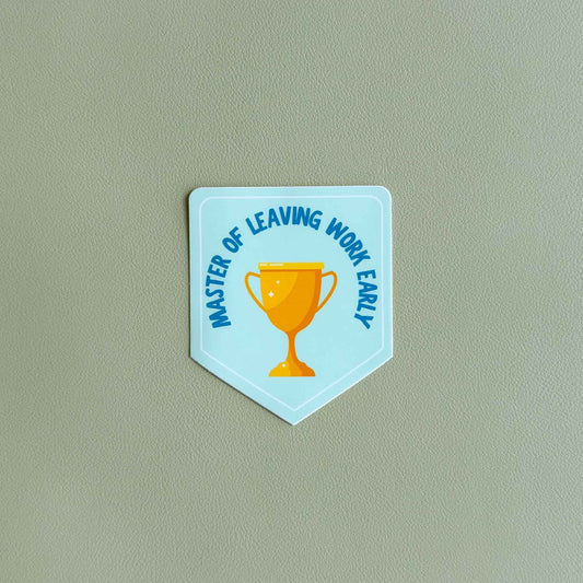 Shield-shaped vinyl sticker reading 'Master of leaving work early' in blue text curved around a gold trophy on a light blue background
