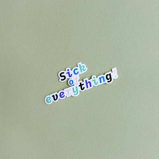 Vinyl sticker that reads 'Sick of everything!' in a playful colorful script font