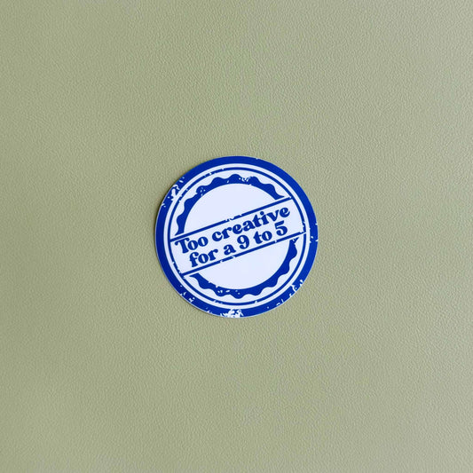 Round vinyl sticker with 'Too creative for a 9 to 5' in white text inside a blue stamp-style circle